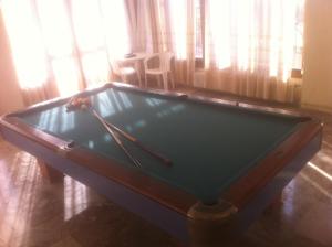 a pool table with two cuesticks on top of it at Esperia in Tolo
