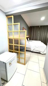 Postel nebo postele na pokoji v ubytování HOTEL DEL REY CURITIBA by POTY - NA FAMOSA RUA XV DE NOVEMBRO