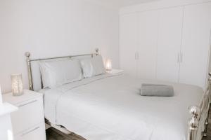 a white bedroom with a large bed with white pillows at Apsley Way, 5 bed 4 bathroom house in Thornaby on Tees