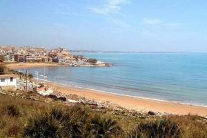 a view of a beach with houses and the ocean at Donna Lucia Home in Pozzallo