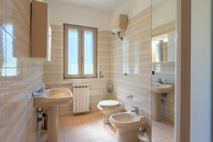 a bathroom with a toilet and a sink and a toilet at Casa Nonno Pietro A - Sorrento Coast in Massa Lubrense