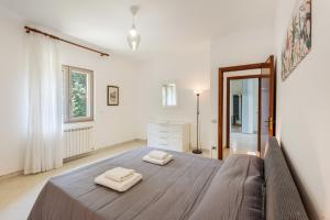 a bedroom with a bed with two towels on it at Casa Nonno Pietro A - Sorrento Coast in Massa Lubrense