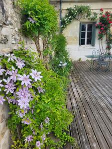 a bunch of flowers on a wooden deck at Maison au cœur des châteaux. in La Chapelle-aux-Naux