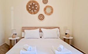 a bedroom with a bed with two towels on it at Porto Blue Horizon in Pefkohori