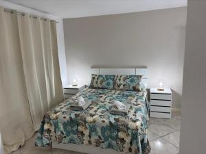 a bedroom with a bed and two night stands at Casa Serena in Los Cristianos