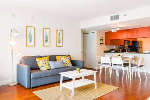 a living room with a blue couch and a table at LUXURY 2 Bedroom Apartment At BRICKELL with pool in Miami