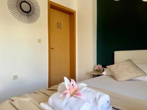 a room with a bed with a towel on it at Apartments Ana & Ita in Novalja
