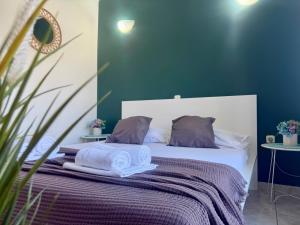 a bedroom with a bed with towels on it at Apartments Ana & Ita in Novalja