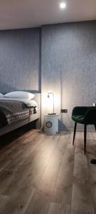 a bedroom with a bed and a table and a chair at Rooms Madison in Zagreb