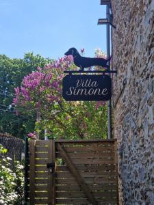 a sign for a wildlife surname on the side of a building at Villa Simone in Spa