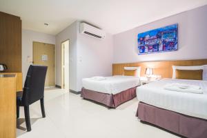 Postel nebo postele na pokoji v ubytování Vapa Hotel - SHA Extra Plus