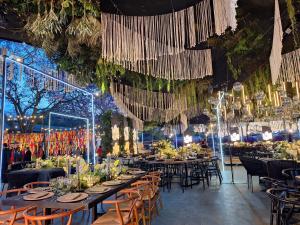 a banquet hall with tables and chairs and chandeliers at Hotel Real de Minas Tradicional in Querétaro