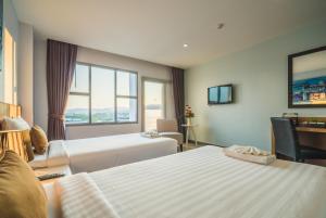 Postel nebo postele na pokoji v ubytování Vapa Hotel - SHA Extra Plus