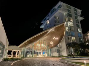 a building at night with a large object on it at Paradisiaca Suite Cancun - BEACH CONDO - 4PX in Cancún +60 photos