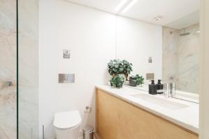 a bathroom with a sink and a toilet at Central Bedroom in Shared House in Chiado - Historic Center of Lisbon in Lisbon