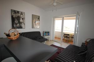 a living room with a black table and chairs at Apartment Vesna in Porat