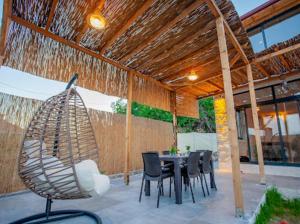 a patio with a table and chairs and a roof at villa sunrise in Demre