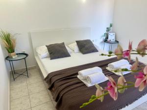 a bedroom with a bed with two pillows on it at Apartments Ana & Ita in Novalja