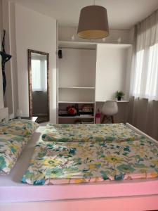 a bedroom with a bed with a colorful comforter at Villa Markisa in Rukavac