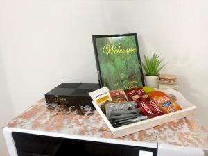 a table with a box of food on top of a microwave at Apartments Ana & Ita in Novalja