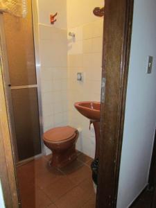 a bathroom with a toilet and a sink at Hotel Imperador in Caldas Novas +26 photos