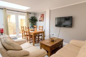 a living room with a couch and a table at Peakstone House in Woodhouse +18 photos