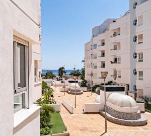 a view of the courtyard of a building with buildings at Elegante piso en la Romanilla in Roquetas de Mar