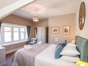 a bedroom with a large white bed with pillows at 43 Springvale in Whitby