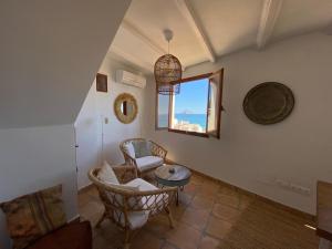 a living room with a table and chairs and a window at Casa Pepita in Altea +29 photos
