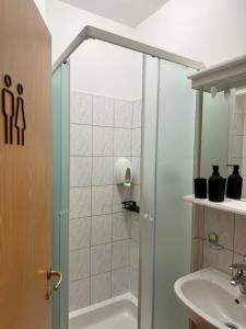 a bathroom with a shower and a sink at Apartments Ana & Ita in Novalja