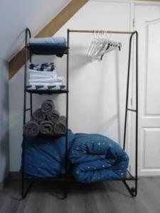 a room with a shelf with clothes and a room with a door at JADE ET JENA in Bazicourt