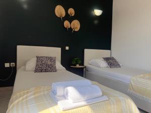 two beds with towels on them in a room at Apartments Ana & Ita in Novalja