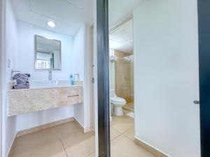 a bathroom with a sink and a toilet at Paradisiaca Suite Cancun - BEACH CONDO - 4PX in Cancún