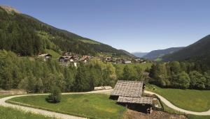 a village in the middle of a valley with a road at Hotel Seerast in Ultimo