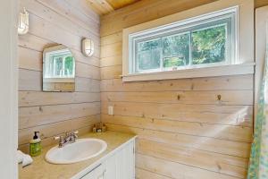 a bathroom with a sink and a window at Rosewater Cottage in Eagledale +17 photos