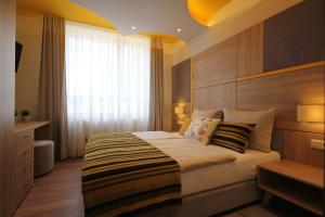 Postel nebo postele na pokoji v ubytování Sarajevo Daily Apartments