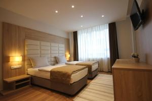 Postel nebo postele na pokoji v ubytování Sarajevo Daily Apartments