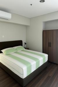 Кровать или кровати в номере Apartment Trillium Residence 2BR