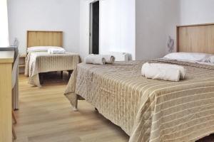 a bedroom with two beds with towels on them at Habitaciones Castillo Deluxe in Sanlúcar de Barrameda