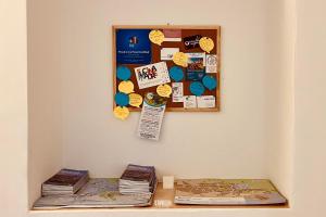 eine Pinnwand an einer Wand mit zwei Büchern in der Unterkunft CentralStay Matera in Matera