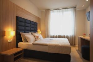 Postel nebo postele na pokoji v ubytování Sarajevo Daily Apartments