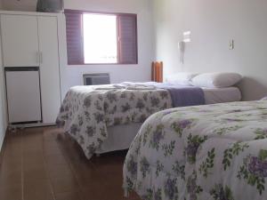 a room with two beds and a window at Hotel Imperador Caldas Novas - GO - Facil acesso aos parques aquaticos e polo gastronômico noturno in Caldas Novas +70 photos