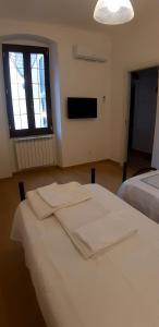 Posteľ alebo postele v izbe v ubytovaní Chez Sabrine - La Spezia Via Fiume 112
