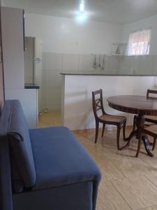 a living room with a couch and a table at Verde Mar Abricó 3 in Rio das Ostras