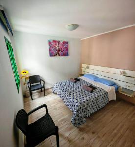 a bedroom with a bed and a chair in it at La casa di marcos in Costa Calma
