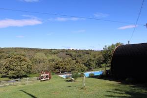 a swimming pool in a field with a park at Quinta Da Devesa B1 in Vinhais