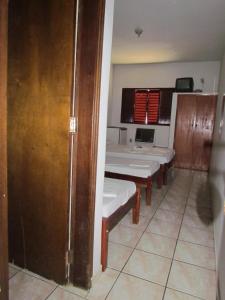 a room with a table and benches in a room at Hotel Imperador in Caldas Novas