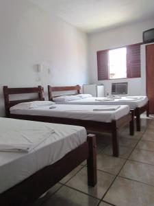 a group of three beds in a room at Hotel Imperador in Caldas Novas