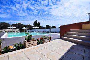 a swimming pool with stairs and a swimming pool at Villa Luigia Luxury Relais in Gallipoli