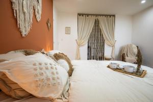 a bedroom with a bed with two cups and a tray on it at Domaine les Hilliers in Bains-sur-Oust +19 photos